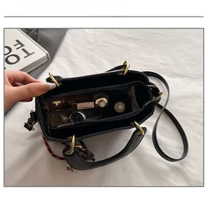 Internal compartments of the black leather handbag showing daily storage capacity