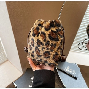 Close-up of leopard print plush bucket bag with drawstring closure and soft faux fur texture