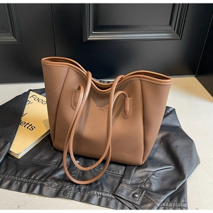 Detailed texture of brown pebble leather tote bag with Fashion Trend logo text