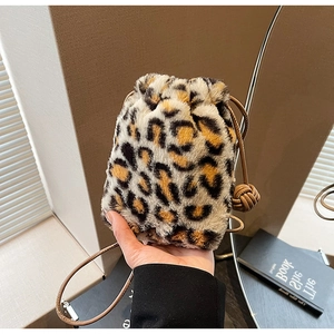 Detail of leopard print faux fur bucket bag with leather drawstring closure and texture