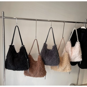 Row of plush hobo shoulder bags in assorted colors with sleek metal chains and straps