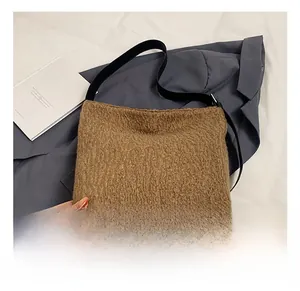 Detail showing brown plush faux shearling texture with black leather base and strap