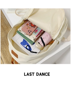 Top view of cream school backpack interior showing large capacity for books and umbrella