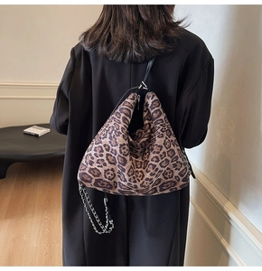 Detailed view of leopard print hobo bag with silver chain strap and metal zipper