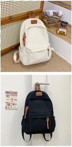 Detail view of stylish canvas backpacks in cream and black with faux leather accents