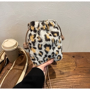 Close-up of leopard print plush bucket bag with drawstring closure and soft texture