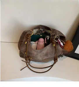 Detail view of spacious brown tote bag interior holding umbrella and accessories