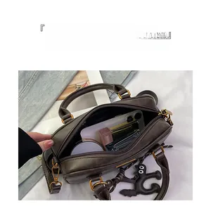 Top view of a retro brown pillow bag showing spacious interior with cosmetics and accessories