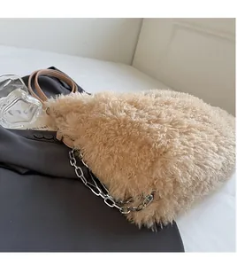 Detail of beige faux shearling handbag showing silver chain and plush texture