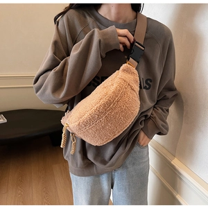 Detail view of the warm khaki lamb wool texture on the crossbody chest bag and strap