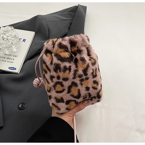Detail of plush leopard print bucket bag with pink leather drawstring and knot detail