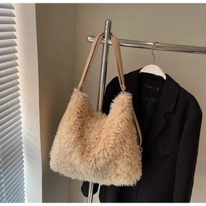 Detail of soft cream plush faux fur shoulder bag with leather strap and metal rings