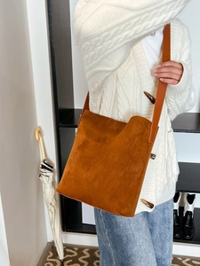 Brown suede bucket bag for women featuring a minimalist large capacity shoulder design