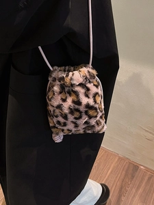 Leopard print plush bucket bag with drawstring closure and slim shoulder strap