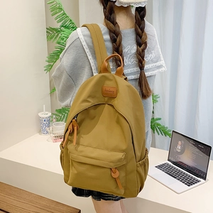 Student backpack in khaki yellow fabric with zip pocket and stylish side pockets