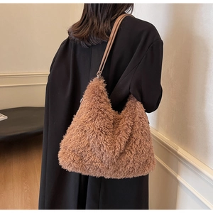 Close-up of fluffy faux fur shoulder bag in camel brown with elegant leather straps