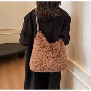 Detailed view of the brown fuzzy faux fur tote bag showing the soft texture and leather strap