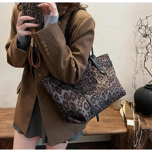Chic leopard print tote bag styled on a model in a cozy autumn-themed setting