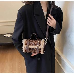 Détail du sac bandoulière léopard avec bordure en similicuir et lanières en cuir brun