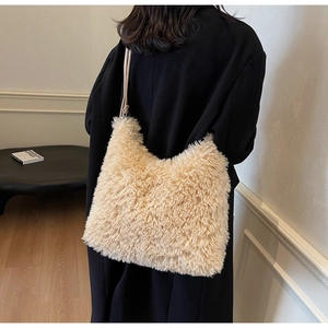 Detailed back view of a plush beige shoulder bag featuring soft faux fur texture