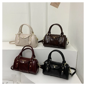 Showcase of four mini Boston bags in white, brown, burgundy, and black with glossy finish