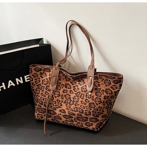 Detailed view of the leopard print texture on a large capacity tote bag with slim straps