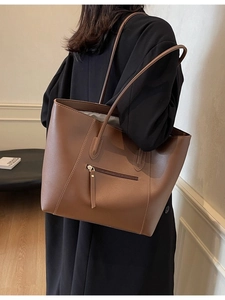 Minimalist dark brown leather tote bag with long shoulder straps for daily commuting