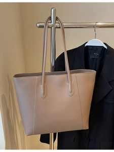 Minimalist beige tote bag with white contrast stitching and large capacity design