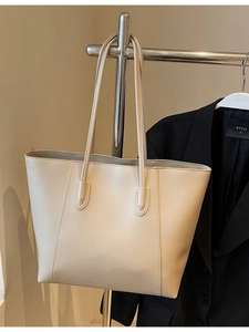 Minimalist beige tote bag in high-quality PU leather with sleek vertical stitching details
