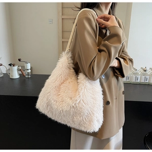 Model wearing a soft pink plush faux fur tote bag with slim shoulder straps for winter