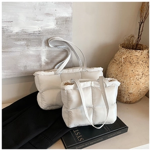 Size comparison of white quilted puffer tote bags in large and small versions