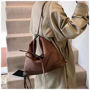 Detail of vintage coffee brown frosted PU tote bag with elegant bow leather tie