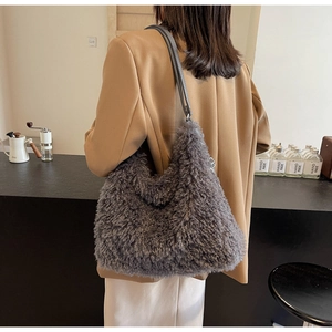 Detailed view of grey plush hobo bag with long faux fur and slim leather shoulder strap