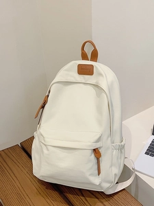 Minimalist beige campus backpack with premium brown leather details and large front pocket