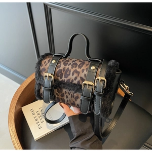 Vue détaillée du sac cylindre léopard en fausse fourrure avec lanières et rivets dorés