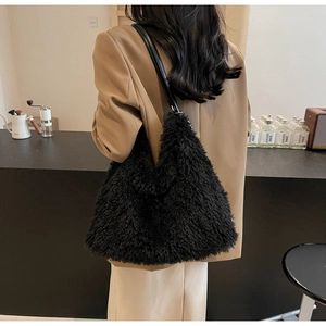 Detail of fuzzy black plush tote bag texture with slim leather shoulder straps