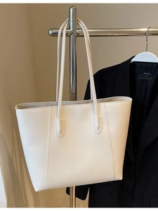 Minimalist large capacity cream tote bag with fine stitching and long shoulder straps