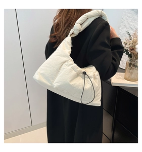 Quilted cream nylon shoulder bag with oversized knot detail and drawstring side pocket