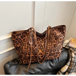 Close-up of leopard print tote bag on leather cushion with chic minimalist background