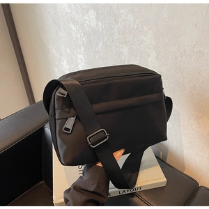 Detail of minimalist waterproof nylon crossbody bag with adjustable strap and smooth zipper