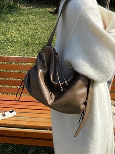 Brown leather hobo shoulder bag with pleated design and knot detail for women