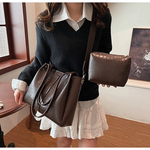 Detail of dark brown faux crocodile leather tote bag set with matching inner pouch