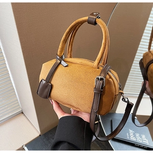 Detail of vintage ginger frosted leather Boston bag with brown straps and silver hardware