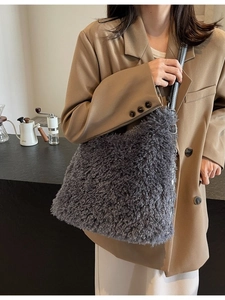 Furry dark grey shoulder bag in plush faux shearling shown on a casual model outfit