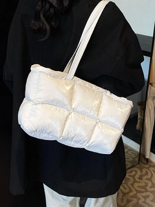 Glossy white quilted down tote bag for women featuring a spacious and minimalist design