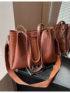 Vintage brown crocodile pattern tote bag with wide woven strap and metal rivets details