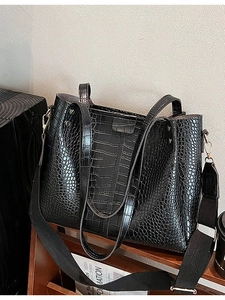 Fashionable black faux crocodile skin tote bag with top handles and adjustable strap