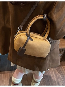 Matte ginger yellow crossbody bag with dual leather handles and adjustable shoulder strap