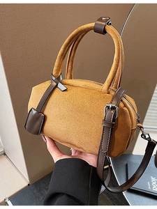 Suede-textured mustard Boston bag with dark brown leather straps and silver zippers