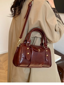 Retro burgundy Boston pillow handbag with gold hardware and adjustable crossbody strap